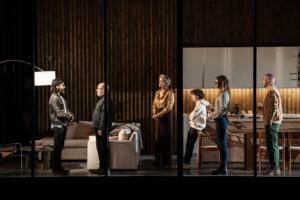 Production shot from Phaedra at the National Theatre in February 2023 showing the cast standing in a sitting room
