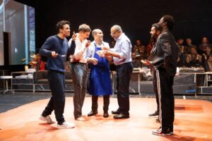 A group of actors stand in a semi circle in a scene from A Little Life at the Harold Pinter Theatre in London 2023