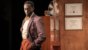 Ivanno Jeremiah standing hands in pockets in the Kiln Theatre production of Retrograde by Ryan Calais Cameron