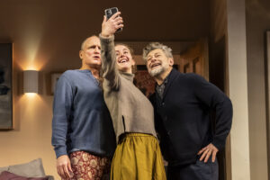 Woody Harrelson, Louisa Harland and Andy Serkis group for a selfie in a scene from Ulster American at the Riverside Studios in London December 2023.