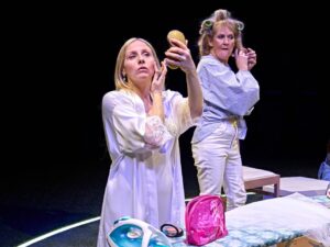 A bridfe and her aunt played by actors are doing their makeup and hair in Till The Stars Come Down at the National Theatre February 2024