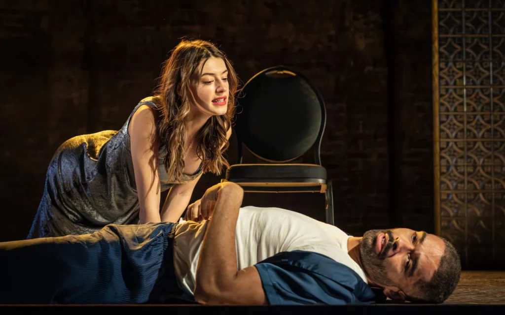 Actor Kingsley Ben-Adir lies on his back while actor Daisy Edgar-Jones leans over him in a scene from Cat On A Hot Tin Roof at the Almeida Thetare